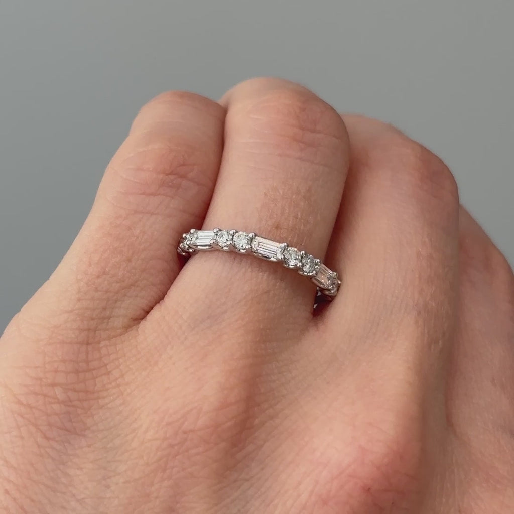 Video of a white gold lab grown diamond alternating baguette and round band worn on the hand, two cuts catching light differently in motion.
