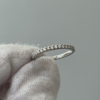 Video of a white gold lab grown diamond micro pavé band on a gloved hand, fine stone line turning through the light.
