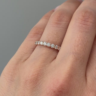 Video of a rose gold lab grown diamond shared prong band worn on the hand, continuous stone line in motion.