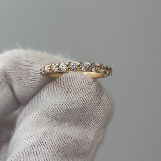 Video of a lab grown diamond half eternity scallop band on a gloved hand, stone row catching light as it turns.