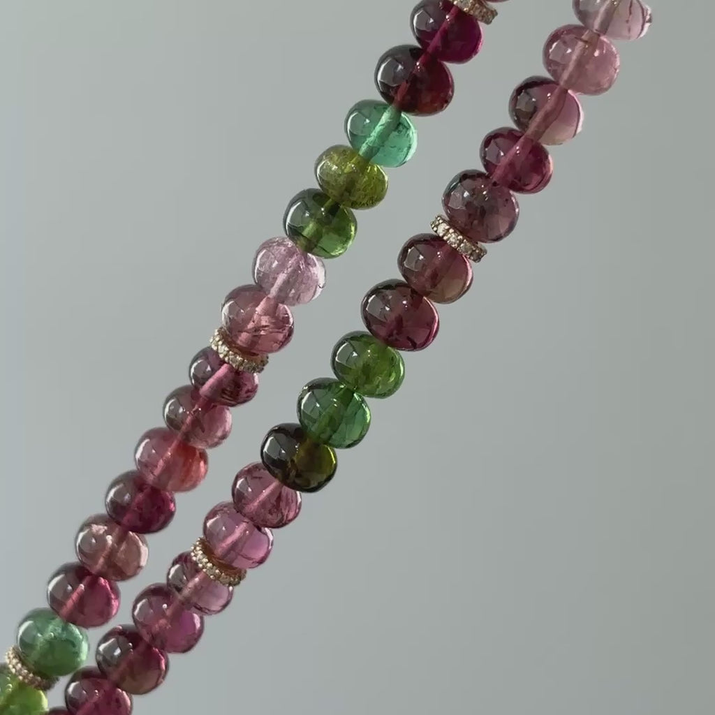 Video of a natural multi-color Tourmaline oval bead necklace, doubled strand showing bead color variation and gold spacers in motion.