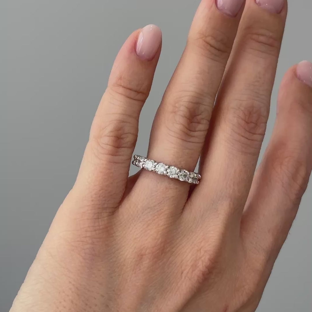 Video of a white gold lab grown diamond half eternity band worn on the hand, scallop set round brilliants in motion.