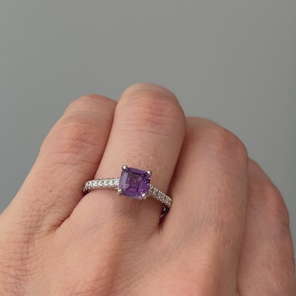 Video of a white gold Asscher cut purple Sapphire engagement ring worn on the hand, stepped facets shifting the violet in motion.