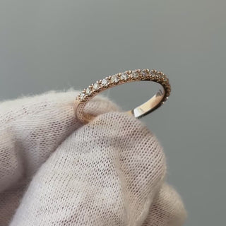 Video of a rose gold natural Diamond micro pavé band on a gloved hand, fine stone line turning through the light.