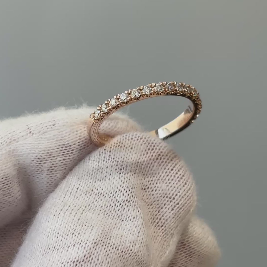 Video of a rose gold natural Diamond micro pavé band on a gloved hand, fine stone line turning through the light.
