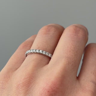 Video of a white gold lab grown diamond micro pavé band worn on the hand, fine stone row catching light in motion.