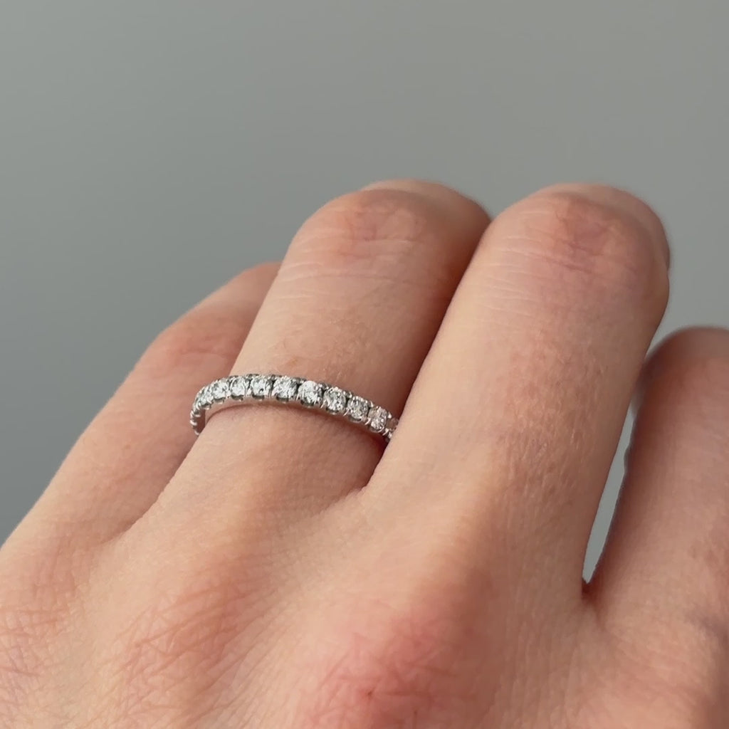 Video of a white gold lab grown diamond micro pavé band worn on the hand, fine stone row catching light in motion.