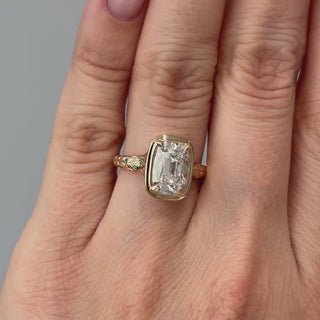Video of a yellow gold old mine cushion lab grown diamond solitaire worn on the hand, high crown facets catching light in motion.