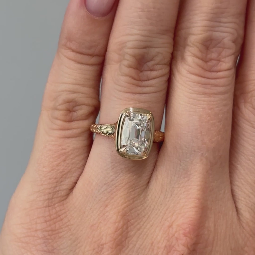 Video of a yellow gold old mine cushion lab grown diamond solitaire worn on the hand, high crown facets catching light in motion.