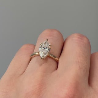 Video of a yellow gold marquise cut lab grown diamond flower head solitaire worn on the hand, pointed silhouette turning through the light.