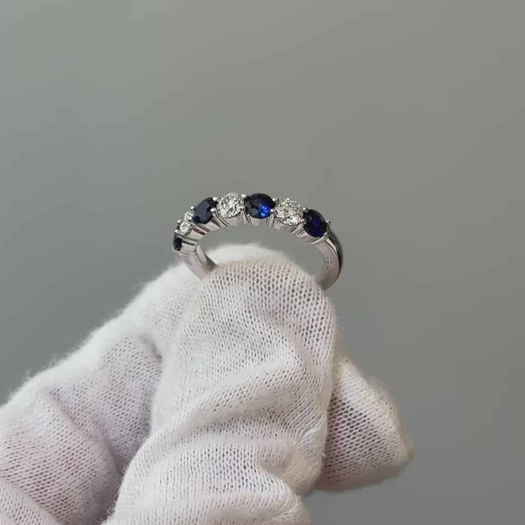 Video of a white gold natural Ceylon blue Sapphire and Diamond band on a gloved hand, blue and white stones in motion.