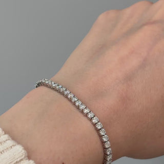 Video of a white gold natural Diamond tennis bracelet worn on the wrist, round brilliant stones in motion.