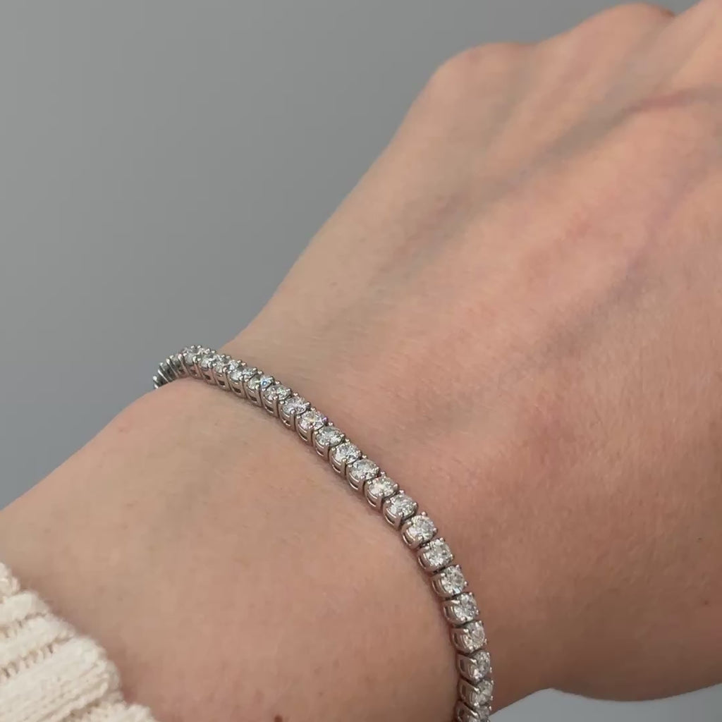 Video of a white gold natural Diamond tennis bracelet worn on the wrist, round brilliant stones in motion.
