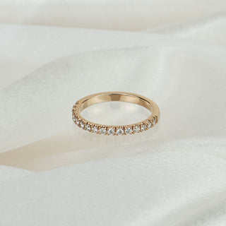 Natural Diamond micro pavé wedding band in rose gold on satin fabric, sixteen round brilliants across the front.