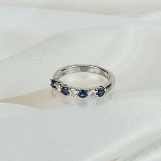Natural Ceylon blue Sapphire and Diamond wedding band in platinum on satin fabric, four sapphires alternating three round brilliants in shared claws.