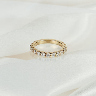 Lab grown diamond half eternity band in yellow gold on satin fabric, eleven round brilliants in scallop shared claws.