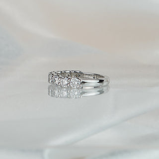 Side view of a lab grown diamond scallop band in white gold, stone row tapering to a plain polished back.