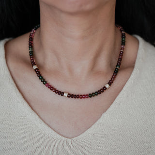 Tourmaline oval bead necklace in natural multi-color worn at the neckline, 18 inch length with gold spacers visible.