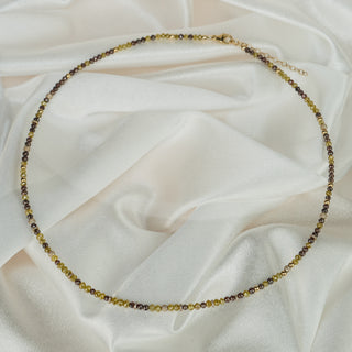 Necklace with small beads on a white fabric background